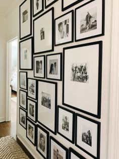 a wall with many pictures hanging on it's sides and wooden floors next to a door