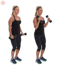 a woman holding two dumbbells in both hands