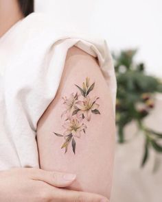 a woman's arm with flowers painted on it