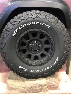 an off - road vehicle tire on display in a museum