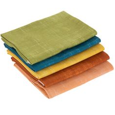 four different colored linens stacked on top of each other in various sizes and colors