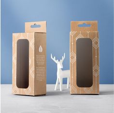 a cardboard box with a deer in front of it and a paper package on the side