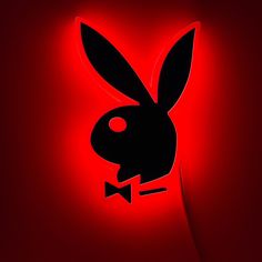 the rabbit is wearing a bow tie and standing in front of a red background with black outline