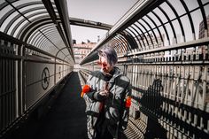 a person standing on a bridge with buildings in the background