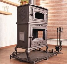 a stove sitting on top of a hard wood floor next to a potted plant