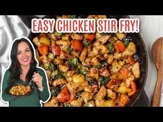 a woman holding a plate of food next to a skillet filled with chicken and veggies