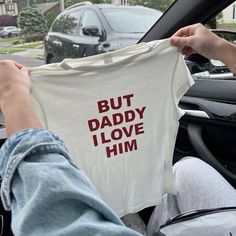 someone holding up a t - shirt that says but daddy i love him in red