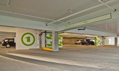 an empty parking garage with cars parked in it