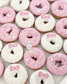 pink and white donuts with bows on them