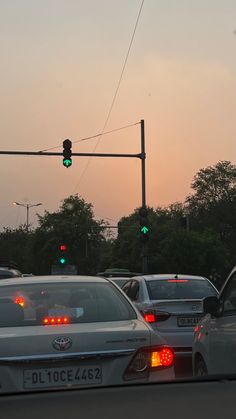 traffic stopped at an intersection with green lights