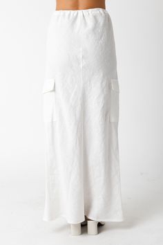 The Kaia White Linen Cargo Maxi Skirt is the perfect vacation cover-up! White linen woven fabric shapes this cargo maxi skirt with a mid-rise fit and drawstring tie. Style with sandals and a cute top and wear to dinner! DETAILS & FIT Loose Fit. 100% Linen. Machine wash cold. Imported. Beach Cotton Skirt With Drawstring, Relaxed Cargo Skirt With Elastic Waistband For Summer, Summer Cargo Skirt With Elastic Waistband And Relaxed Fit, Summer Cargo Skirt With Elastic Waistband, Summer Beach Bottoms With Cargo Pockets, Cotton Cargo Skirt With Elastic Waistband For Summer, Relaxed Linen Maxi Skirt For Vacation, Wide Leg Bottoms With Cargo Pockets For Vacation, White Maxi Length Summer Bottoms