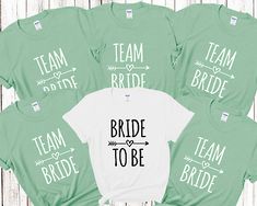 the bride and groom shirts are on display in front of a wooden background with arrows