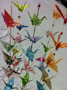 there are many origami birds on the snow