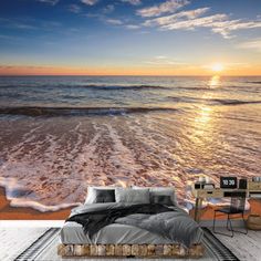 the sun is setting over the ocean with waves crashing on the beach wallpaper mural