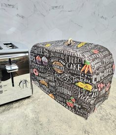 a black and white oven mitt sitting next to a toaster