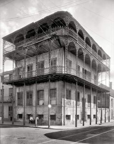 an old building with balconies on the top and second story is shown in this black and white photo