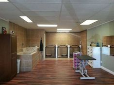 an empty room with wooden floors and tile walls