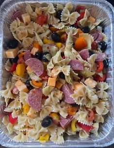 a plastic container filled with pasta and veggies