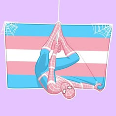 a spider - man hanging upside down on a pink and blue striped rug with his hands in the air