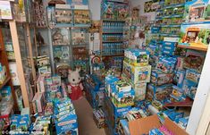 a store filled with lots of toys and boxes on the floor in front of it