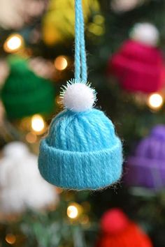 a knitted hat ornament hanging from a christmas tree