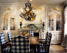 a dining room table with chairs and a chandelier