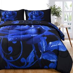 a blue rose comforter set on a wooden floor