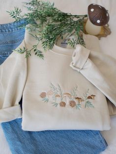 If you love plants, the outdoors and cottagecore, then you're going to love our comfy Woodland Mushroom sweatshirt. This cozy crewneck would also make the perfect gift for a fellow fungi lover! The pictured sweatshirt color is Sand (Beige) If you'd like a different color sweatshirt than those listed, please contact me before placing your order. I would be happy to accommodate your request. This sweatshirt is unisex sized, meaning it has a boxy fit. Please reference the size chart in the photos section for more information on fit. Material: 8 oz., 50/50 cotton/polyester Mushroom Sweatshirt, Beige Sweatshirt, Color Sweatshirt, Cottagecore Vintage, Style Cottage, Vintage Pullovers, Embroidered Crewneck, Sand Beige, Vintage Sweater