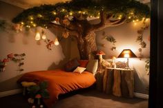 a bedroom decorated in orange and white with a tree on the wall next to the bed