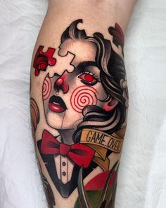 a woman's leg with a tattoo on it that says game over and a red bow tie around her neck