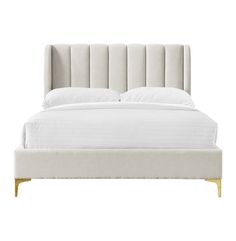 the bed is made with white linens and gold trimming on it's headboard