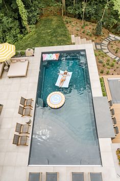 an aerial view of a swimming pool with lounge chairs