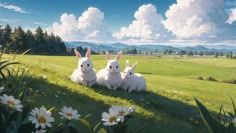 three white rabbits sitting on top of a lush green field