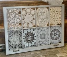 an old window has been decorated with crochet doily