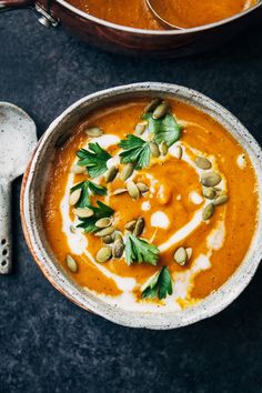 two bowls filled with soup on top of a table