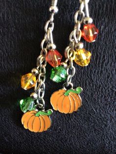 (13,034) Autumn Earrings  Made from stainless enamel, glass beads and stainless steel chain  A) Maple Leaf with Beads B) Pumpkin with orange, yellow and green beads C) Pumpkin with yellow, red and orange beads Orange Czech Glass Dangle Earrings, Nickel-free Yellow Dangle Beaded Earrings, Nickel Free Yellow Dangle Beaded Earrings, Orange Metal Earrings As A Gift, Orange Metal Earrings As Gift, Orange Enamel Earrings Nickel Free, Orange Dangle Jewelry With Colorful Beads, Nickel-free Orange Enamel Earrings, Orange Dangle Jewelry With Lobster Clasp