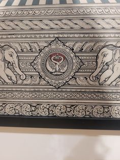 an intricately designed box with elephants on it's sides and a heart in the middle