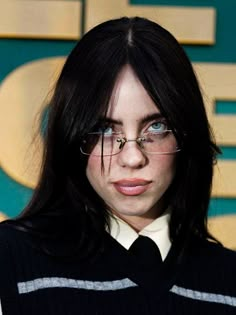 a close up of a person wearing glasses with long hair and eyeglasses on