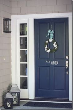 a blue front door with wreaths on it and an email message that says save