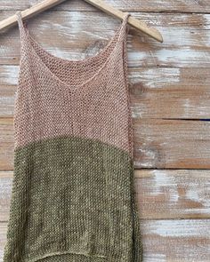 a tank top hanging on a wooden wall