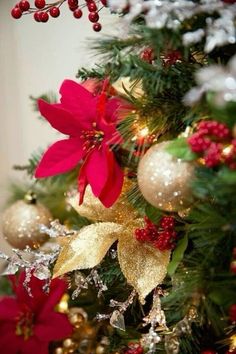 a christmas tree with poinsettias and other decorations