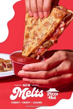 a person holding a slice of pizza in their hand and dipping it into a bowl