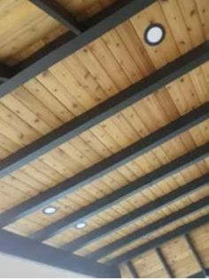 the ceiling is covered with wooden planks and lights