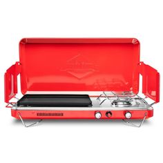 the portable stove is red and has two burners on each side, with an open lid