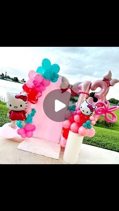 the hello kitty balloon arch is decorated with balloons