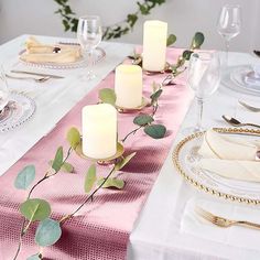 the table is set with candles and place settings