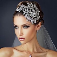 a woman wearing a bridal veil and necklace