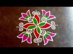 an intricate design on the surface of a wooden table with white and pink flowers painted on it