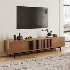 a flat screen tv mounted to the side of a wooden cabinet in a living room