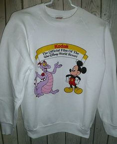 Vintage Disney sweatshirt is in very good, pre-owned condition. Characters on front are Mickey Mouse and Figment "Fig" from Walt Disney Epcot Center.  Banner on shirt reads: Kodak The Official film of the Walt Disney World Resort.   Adult Size Small (see measurements) Fruit of the Loom Long Sleeve Crew neck Vintage from 1990's 50% Polyester / 50% Cotton blend material Measurements: Armpit - Armpit: 17.5 Sleeve (underarm to bottom of sleeve): 19" Back length: 22" Disney Figment, Disney Sweatshirt, Epcot Center, Mickey Mouse Sweatshirt, Disney Epcot, Disney Sweatshirts, Sweatshirt Vintage, Disney World Resorts, Vintage Disney